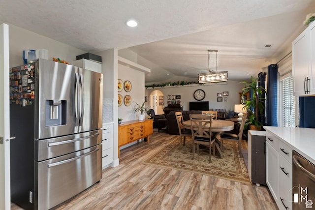 657 W 150 S, Hurricane, UT 84737 - kitchen featuring white cabinets, open floor plan, light countertops, appliances with stainless steel finishes, and decorative light fixtures