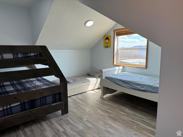 1595 S Bear Lake Blvd, Garden City, UT 84028 - bedroom with light wood-type flooring and vaulted ceiling