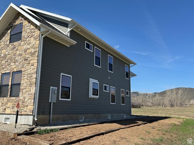 1595 S Bear Lake Blvd, Garden City, UT 84028 - view of side of property featuring crawl space, stone siding, and a mountain view
