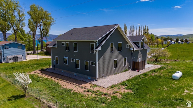 1595 S Bear Lake Blvd, Garden City, UT 84028 - back of property with a mountain view and a lawn