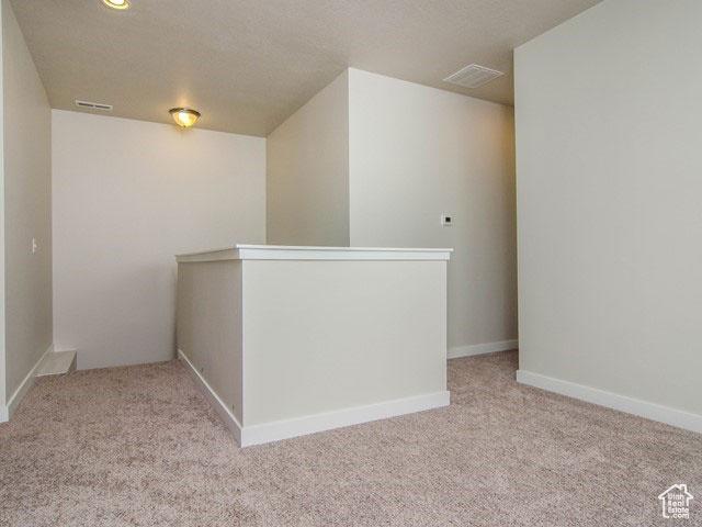 10053 N Torreya Dr Unit 733, Highland, UT 84003 - corridor with an upstairs landing, light colored carpet, visible vents, and a textured ceiling