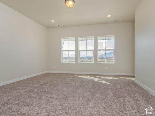 10053 N Torreya Dr Unit 733, Highland, UT 84003 - empty room featuring carpet floors, recessed lighting, plenty of natural light, and baseboards