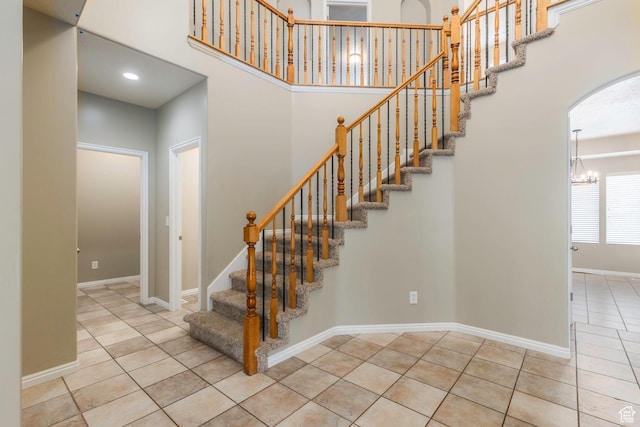 898 E Tendoy Ct S, Draper, UT 84020 - stairway featuring a towering ceiling, baseboards, an inviting chandelier, tile patterned floors, and arched walkways