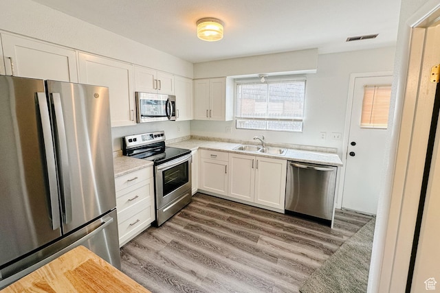 88 W 50 S Unit V-1, Centerville, UT 84014 - kitchen featuring a sink, stainless steel appliances, light countertops, and white cabinets
