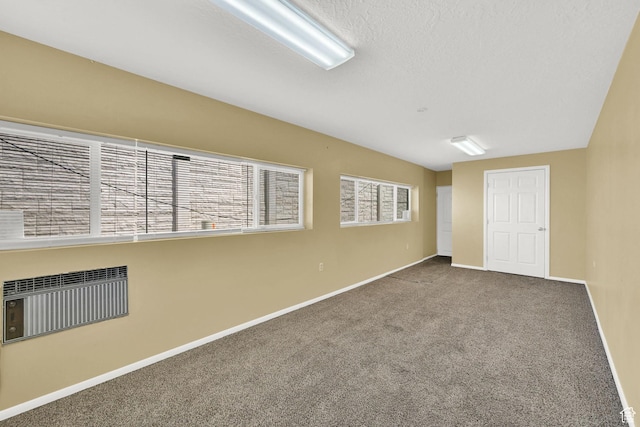 carpeted spare room featuring baseboards