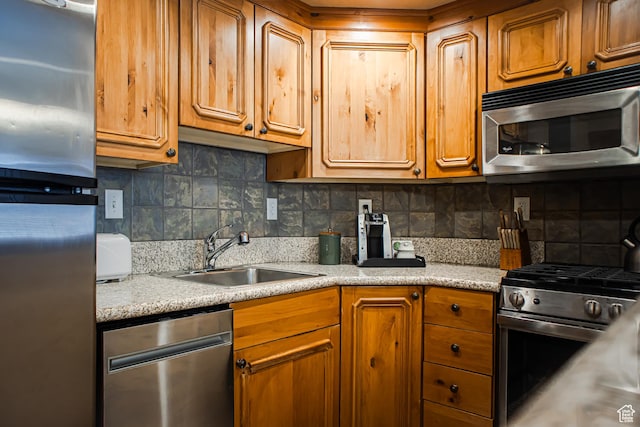 840 W Bigler Ln N Unit 3013, Midway, UT 84049 - kitchen featuring stainless steel appliances, tasteful backsplash, a sink, and brown cabinets