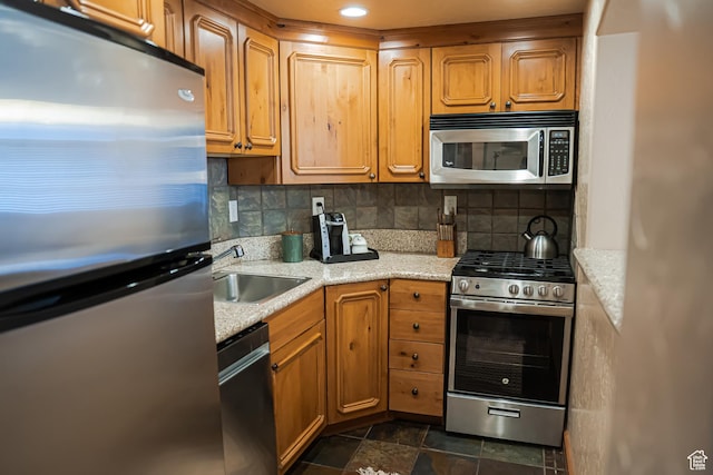 840 W Bigler Ln N Unit 3013, Midway, UT 84049 - kitchen with stainless steel appliances, backsplash, brown cabinets, light stone countertops, and stone finish flooring