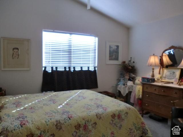 bedroom with vaulted ceiling and carpet flooring