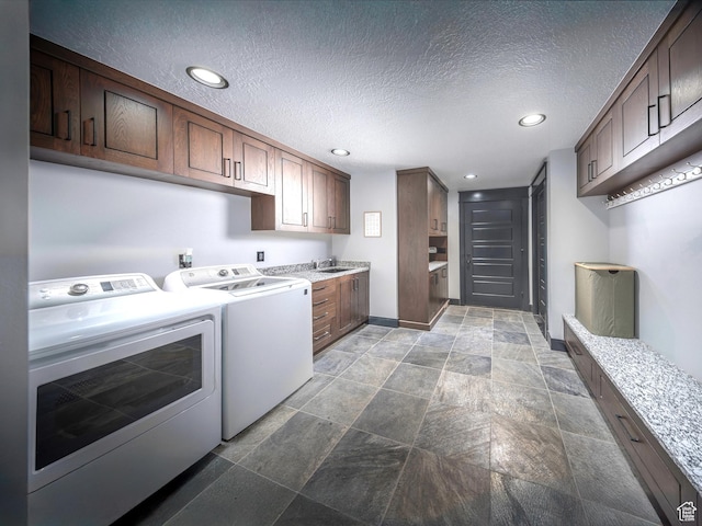 6153 E Last Monument Cir, Salt Lake City, UT 84108 - washroom featuring baseboards, washer and clothes dryer, a textured ceiling, and recessed lighting