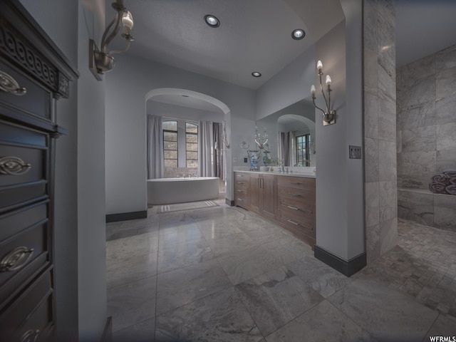 6153 E Last Monument Cir, Salt Lake City, UT 84108 - full bath with baseboards, recessed lighting, a freestanding tub, marble finish floor, and vanity