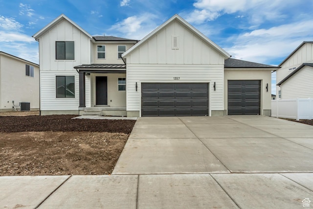 modern farmhouse style home featuring a shingled roof, board and batten siding, an attached garage, a standing seam roof, and driveway