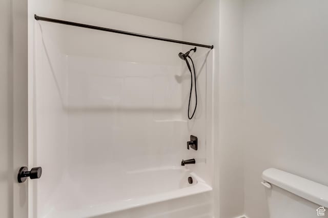 full bath featuring toilet, shower / bathtub combination, and baseboards