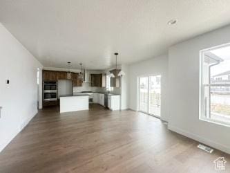 5644 W 7340 S, West Jordan, UT 84081 - unfurnished living room with dark wood-type flooring and baseboards