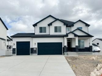 5644 W 7340 S, West Jordan, UT 84081 - view of front of property with a garage, driveway, and stucco siding