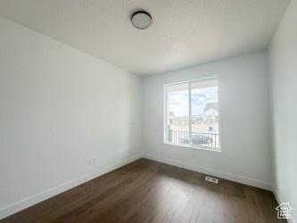 5644 W 7340 S, West Jordan, UT 84081 - empty room featuring baseboards and dark wood finished floors