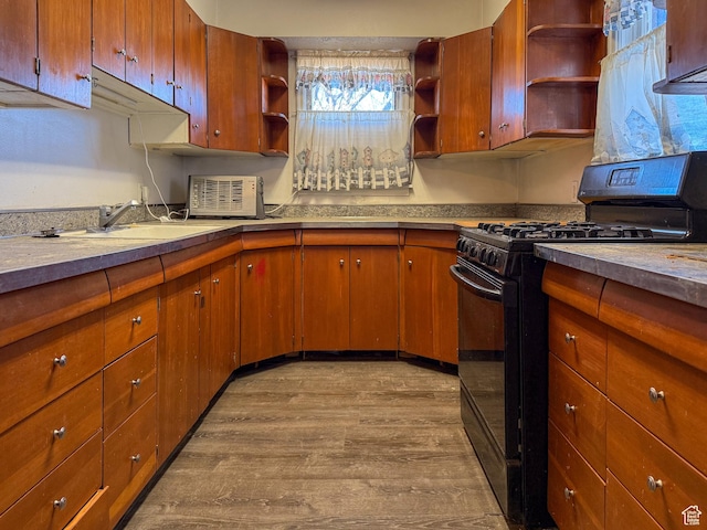 2427 E Main St, Wellington, UT 84542 - kitchen with black range with gas stovetop, light countertops, open shelves, dark wood-type flooring, and a sink