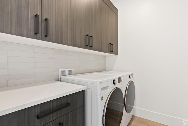 1461 W Canyon Tree Dr, St George, UT 84770 - laundry area featuring light wood finished floors, washer and clothes dryer, cabinet space, and baseboards