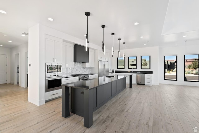 1461 W Canyon Tree Dr, St George, UT 84770 - kitchen with built in appliances, a spacious island, white cabinetry, dark countertops, and pendant lighting