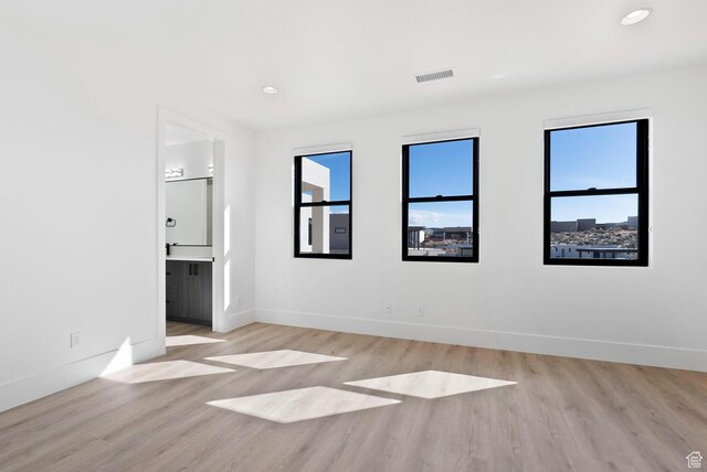 1461 W Canyon Tree Dr, St George, UT 84770 - unfurnished bedroom with light wood finished floors, visible vents, and baseboards
