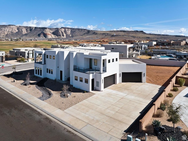 1461 W Canyon Tree Dr, St George, UT 84770 - modern home with stucco siding, a mountain view, a balcony, a residential view, and driveway