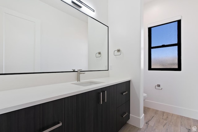 1461 W Canyon Tree Dr, St George, UT 84770 - bathroom featuring baseboards, vanity, toilet, and wood finished floors