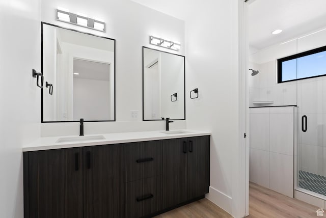 1461 W Canyon Tree Dr, St George, UT 84770 - bathroom featuring double vanity, a shower stall, a sink, and wood finished floors