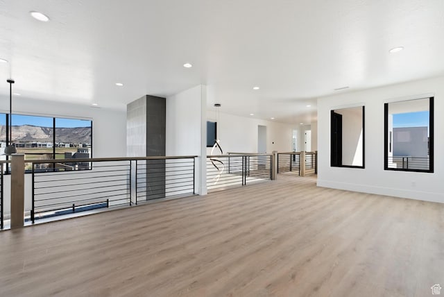 1461 W Canyon Tree Dr, St George, UT 84770 - empty room featuring recessed lighting, baseboards, a mountain view, and light wood finished floors