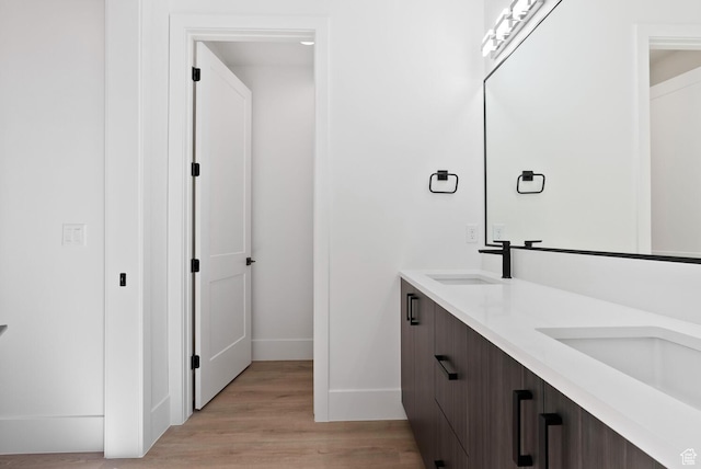 1461 W Canyon Tree Dr, St George, UT 84770 - full bathroom with double vanity, baseboards, a sink, and wood finished floors