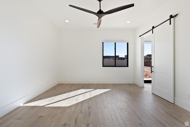1461 W Canyon Tree Dr, St George, UT 84770 - empty room with light wood-style floors, a ceiling fan, recessed lighting, and a barn door