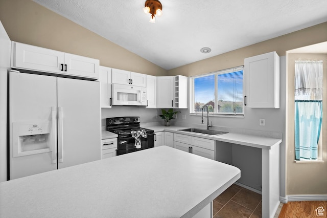 2337 W 2075 N, Clinton, UT 84015 - kitchen with white appliances, vaulted ceiling, light countertops, and white cabinetry
