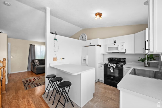 2337 W 2075 N, Clinton, UT 84015 - kitchen featuring white appliances, lofted ceiling, a kitchen bar, white cabinetry, and light countertops