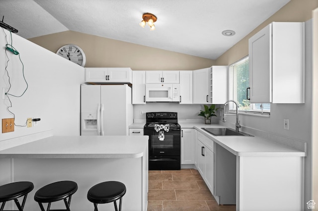 2337 W 2075 N, Clinton, UT 84015 - kitchen with white appliances, lofted ceiling, a breakfast bar area, white cabinets, and light countertops