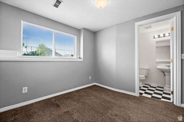 2337 W 2075 N, Clinton, UT 84015 - unfurnished bedroom with ensuite bathroom, carpet, and tile patterned floors