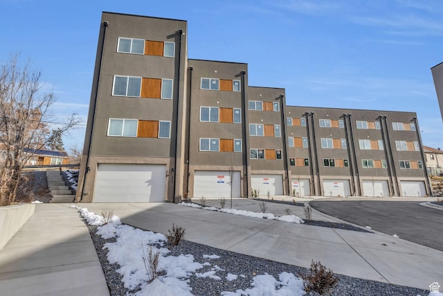 239 E Burch Creek Pl S, Ogden, UT 84405 - snow covered building with a garage and driveway
