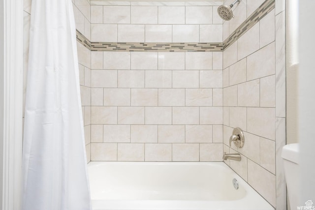 bathroom featuring shower / tub combo with curtain