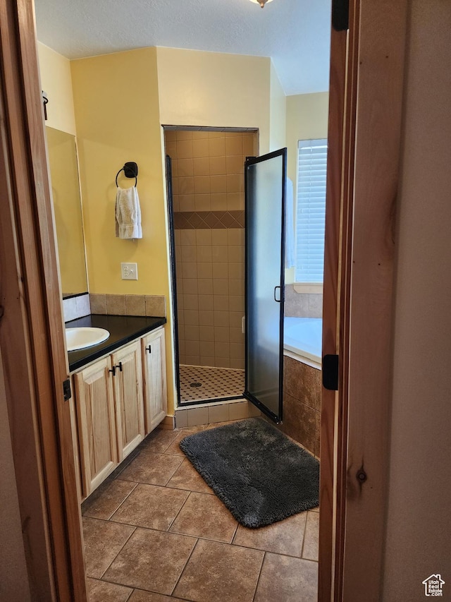 140 E 100 S, Centerfield, UT 84622 - full bathroom with a tub to relax in, a stall shower, tile patterned flooring, and vanity