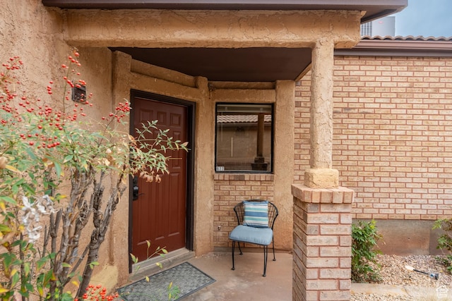 property entrance with brick siding