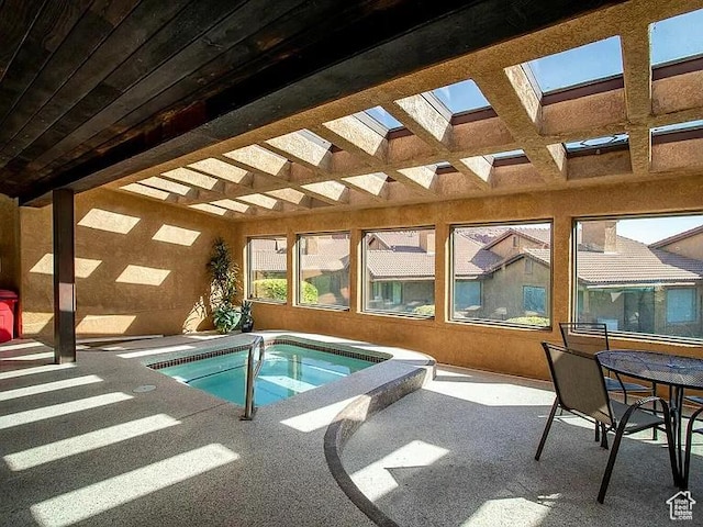 view of swimming pool featuring an indoor in ground hot tub, a patio area, outdoor dining space, and a pergola
