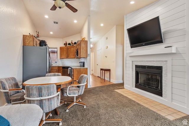 dining space featuring light carpet, a fireplace, visible vents, and recessed lighting