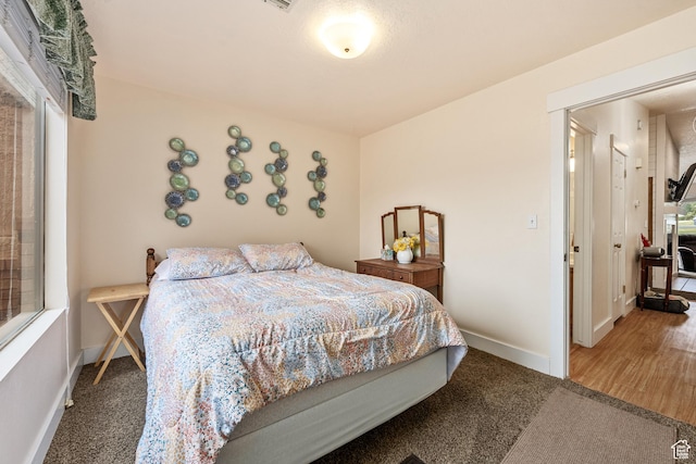 bedroom featuring carpet floors and baseboards