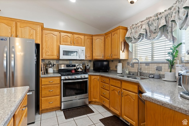 333 S Park St, Grantsville, UT 84029 - kitchen with light stone counters, lofted ceiling, backsplash, appliances with stainless steel finishes, and a sink