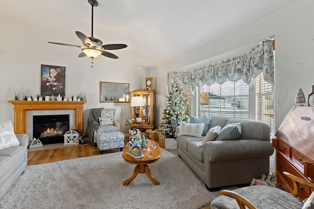333 S Park St, Grantsville, UT 84029 - living area featuring wood finished floors, vaulted ceiling, a tiled fireplace, and ceiling fan