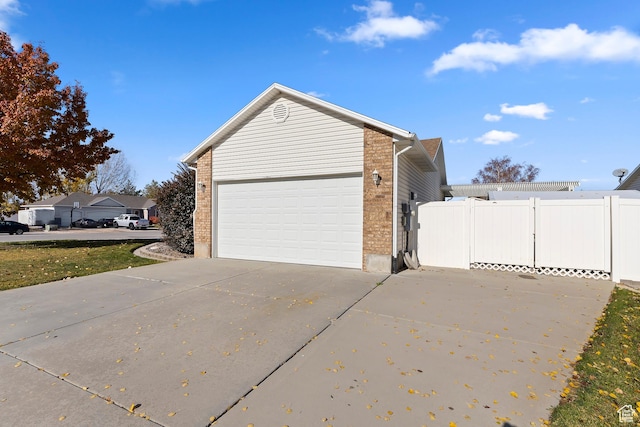333 S Park St, Grantsville, UT 84029 - garage with driveway, a gate, and fence