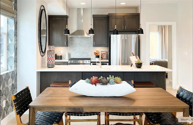 6785 Silver Creek Dr N, Park City, UT 84098 - kitchen featuring high quality fridge, wall chimney exhaust hood, stove, backsplash, and light countertops