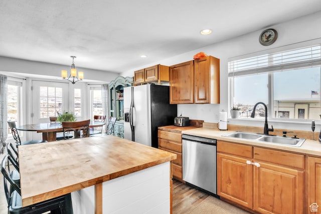 33841 N 7925 E, Fairview, UT 84629 - kitchen with brown cabinetry, butcher block counters, appliances with stainless steel finishes, hanging light fixtures, and a sink