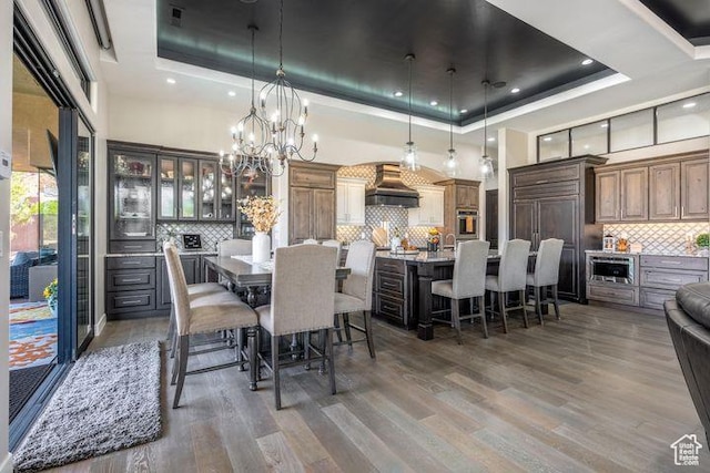 3052 N Snow Canyon Pkwy Unit 201, St George, UT 84770 - dining space featuring a towering ceiling, dark wood-style floors, and a raised ceiling