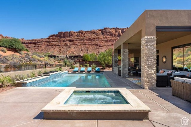 3052 N Snow Canyon Pkwy Unit 201, St George, UT 84770 - view of swimming pool with a fenced in pool, a patio, an outdoor living space with a fireplace, fence, and an in ground hot tub