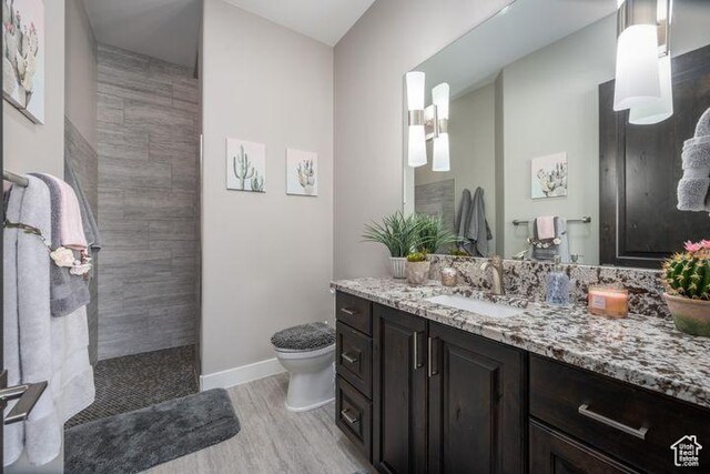 3052 N Snow Canyon Pkwy Unit 201, St George, UT 84770 - full bath featuring a walk in shower, toilet, wood finished floors, vanity, and baseboards