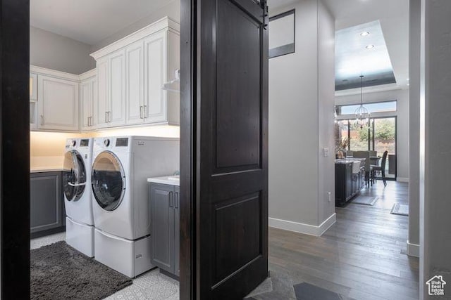 3052 N Snow Canyon Pkwy Unit 201, St George, UT 84770 - laundry room featuring cabinet space, a barn door, baseboards, washer and dryer, and light wood-type flooring