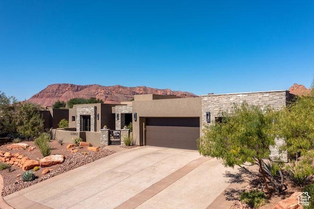 3052 N Snow Canyon Pkwy Unit 201, St George, UT 84770 - southwest-style home with an attached garage, a mountain view, stone siding, driveway, and stucco siding